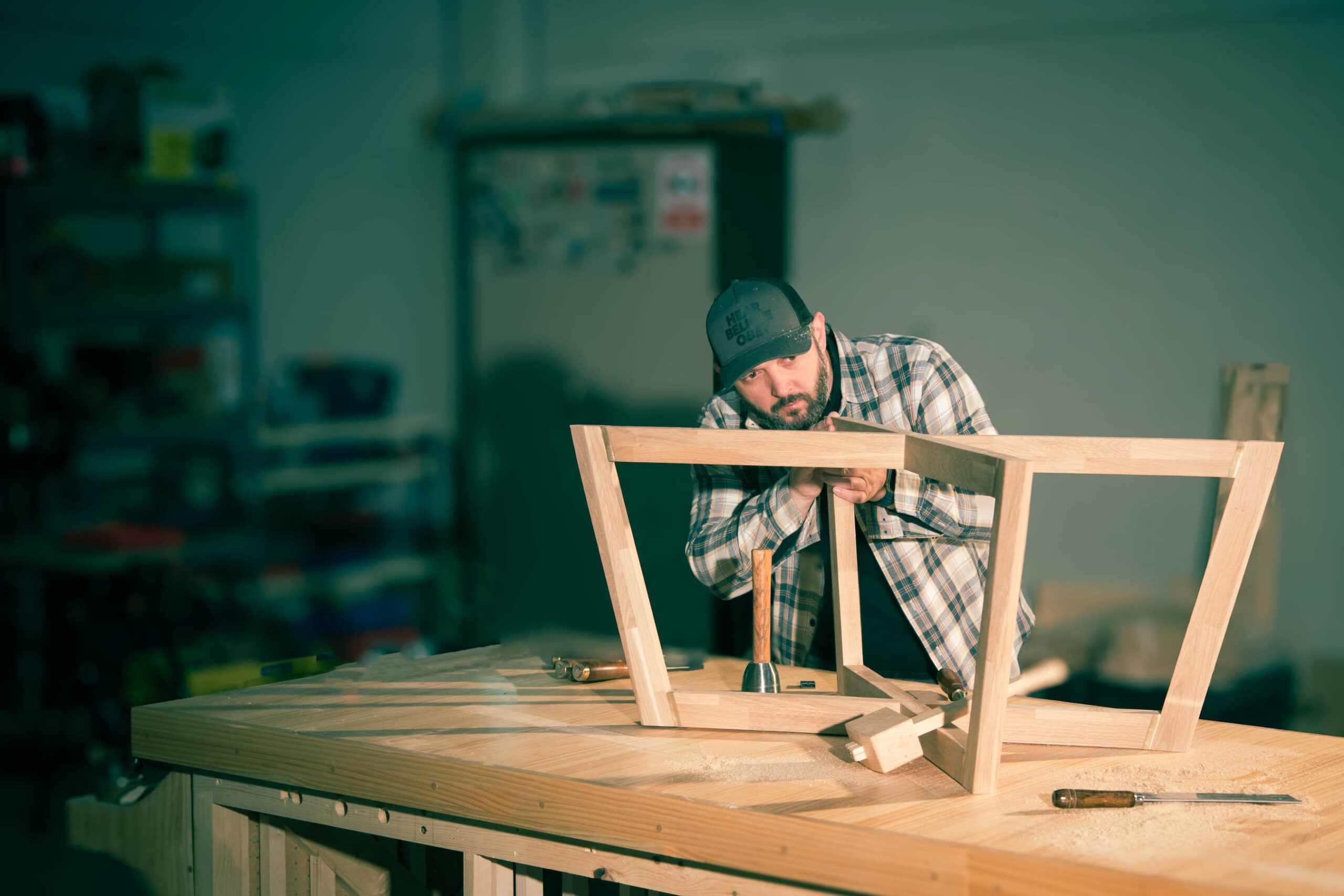 Furniture maker crafting bespoke solid wood furniture in The Wood Wolf workshop in Madrid, Spain.